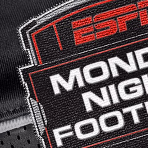 Close-up of an embroidered patch displaying 'ESPN MONDAY NIGHT FOOTBALL' on black textured fabric.