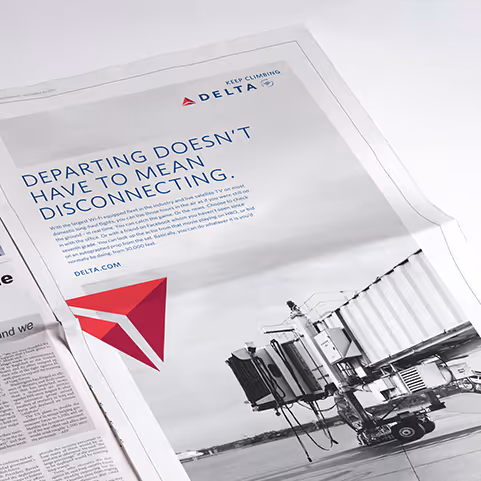 Delta Airlines advertisement in a newspaper stating 'Departing doesn't have to mean disconnecting' with an image of an empty airport jet bridge.