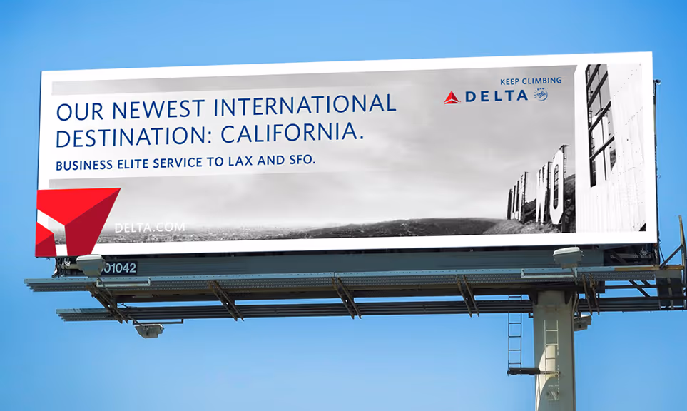 Billboard advertising Delta Airlines' new international destination to California with business elite service to LAX and SFO, featuring partial Hollywood sign in background.