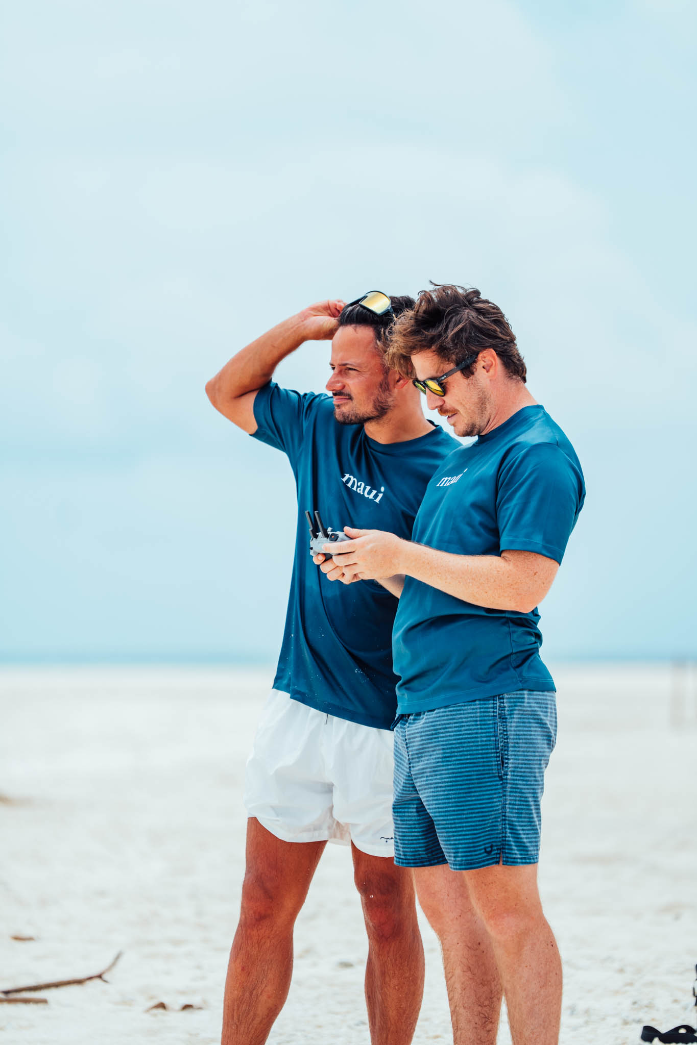 Maui leaders checking a drone shot on the beach