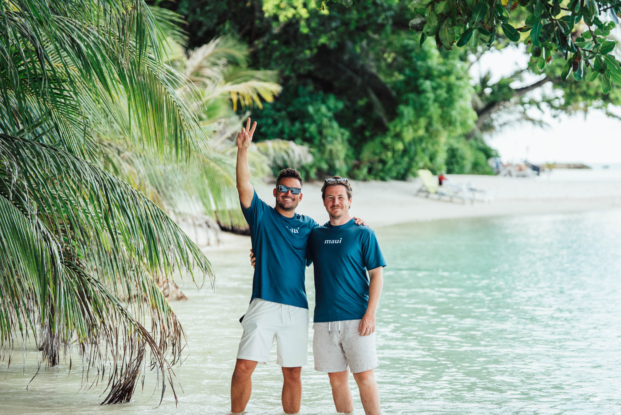 Maui crew waving on a tropical beach