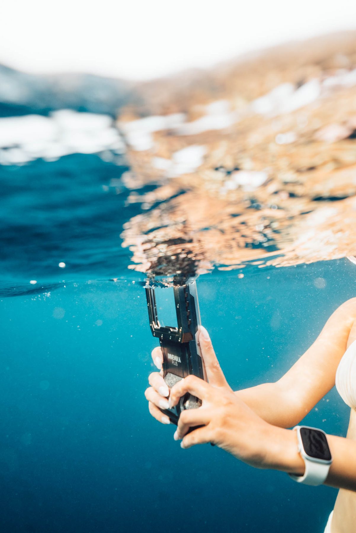 Phone in a DiveVolk housing held half above and half below the waterline
