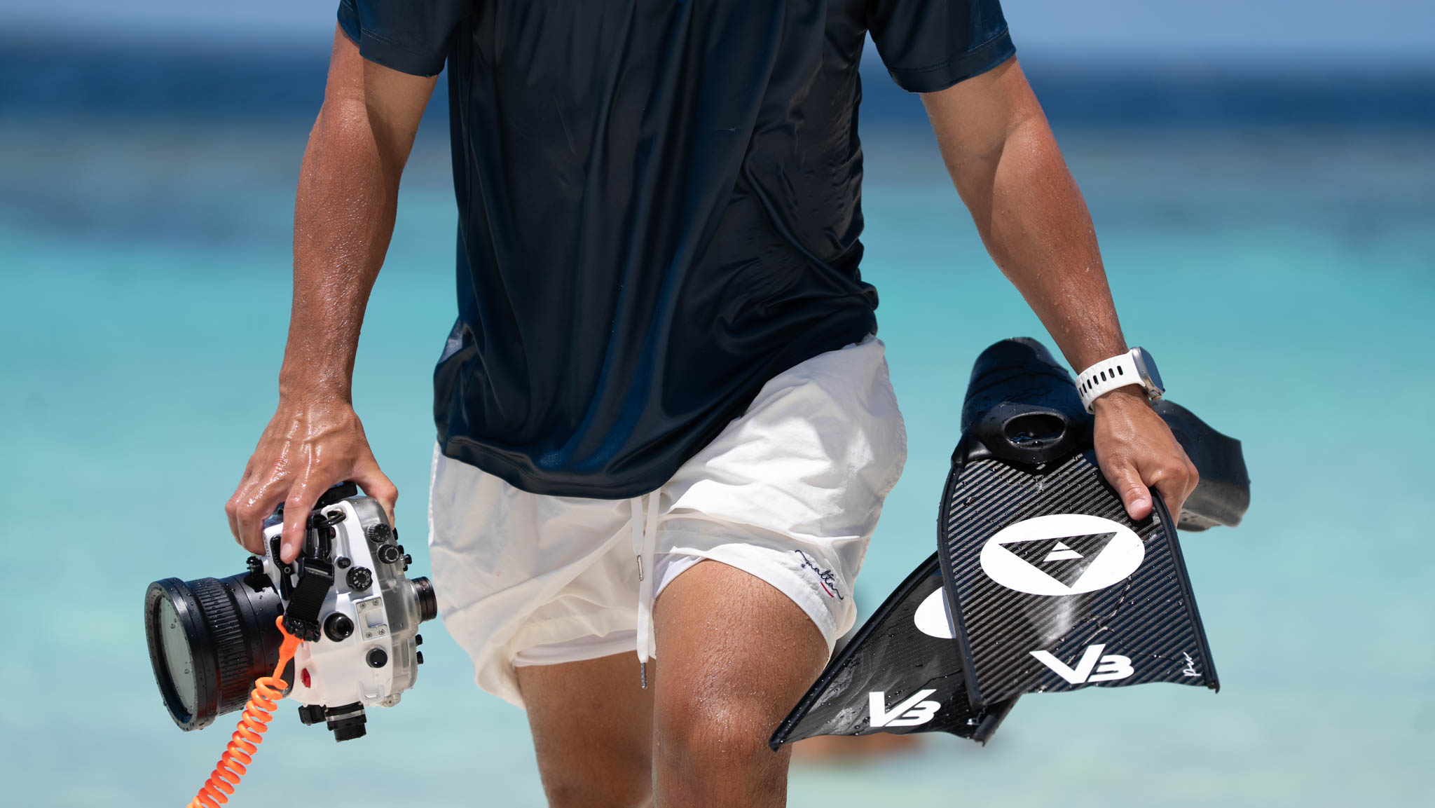 Close-up of Alchemy V3 carbon fins and an underwater camera on the beach