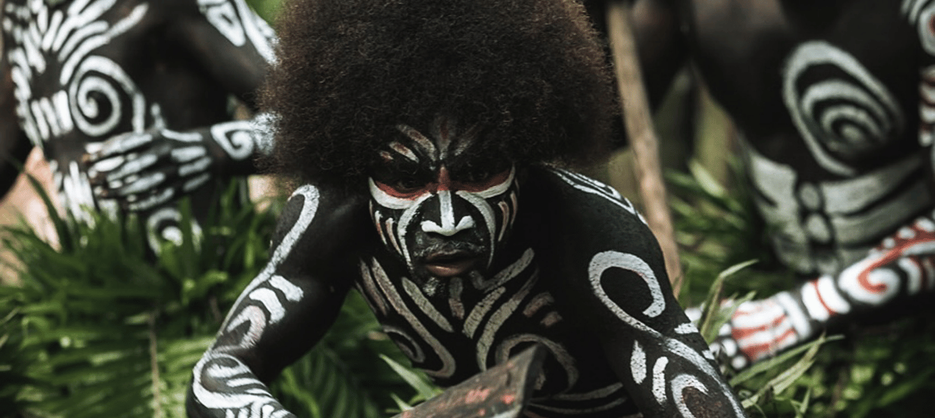Papuan man with traditional white body paint in Raja Ampat