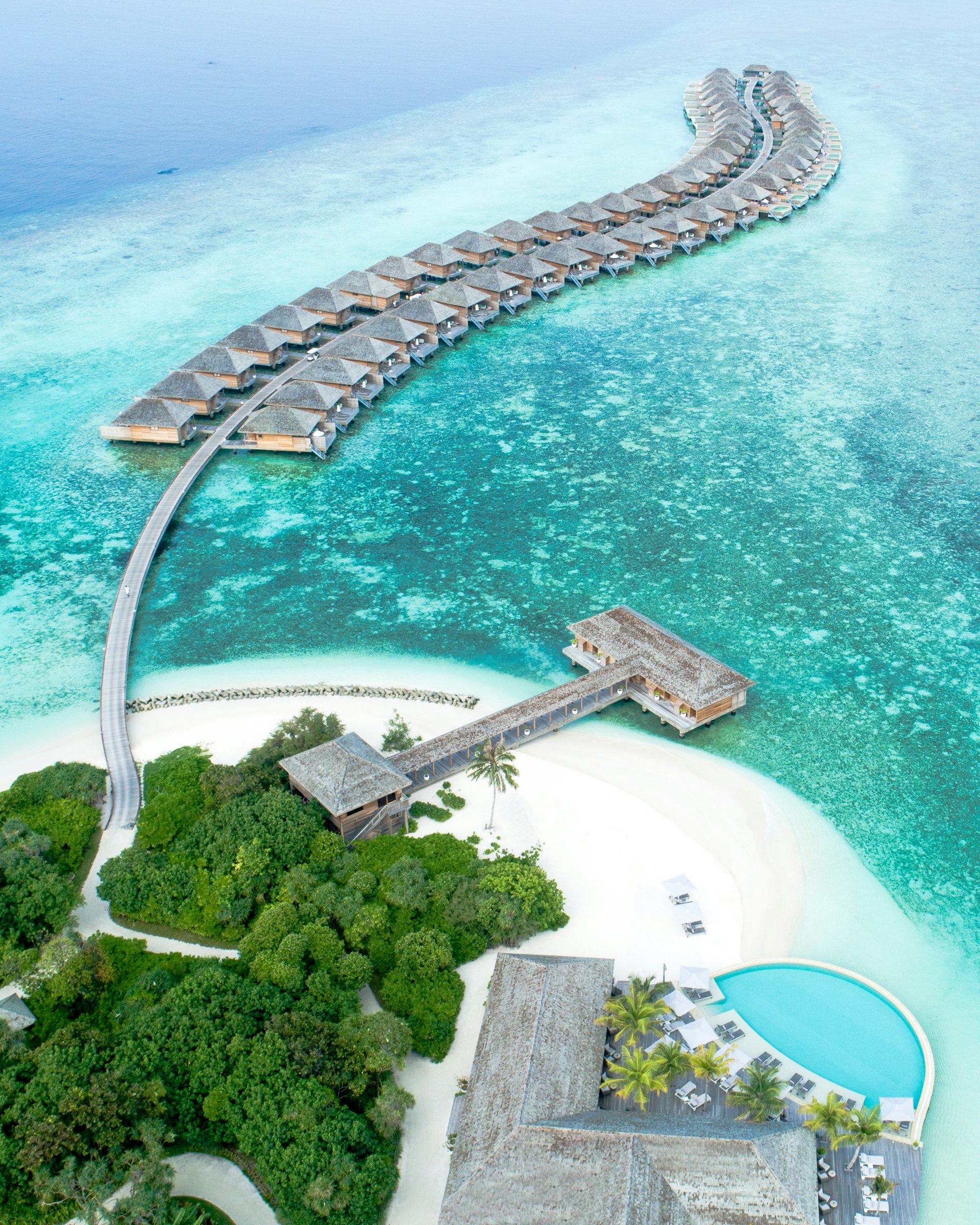 Aerial view of a Maldivian island with houses and turquoise water