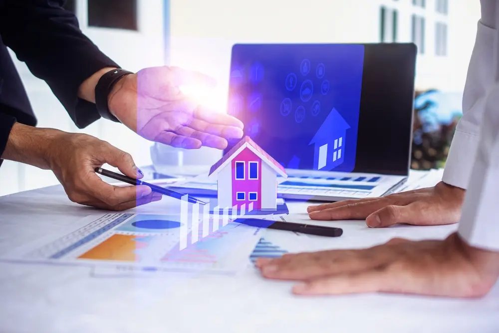 Business meeting discussing real estate automation strategies with charts and a digital house model.
