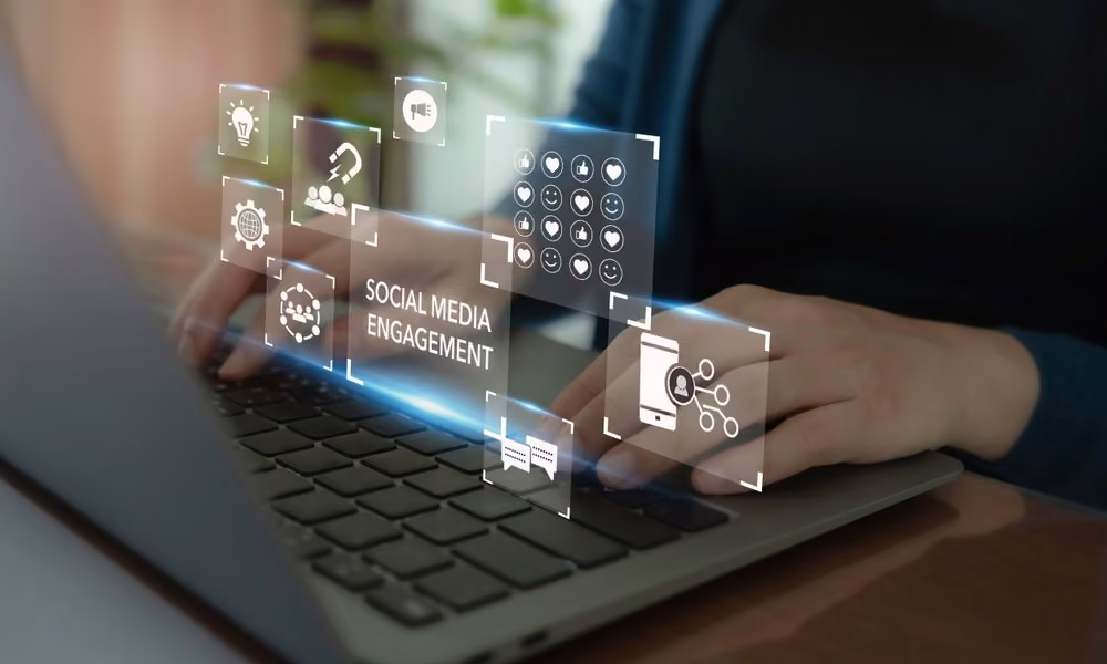 Person typing on a laptop with social media engagement icons overlayed