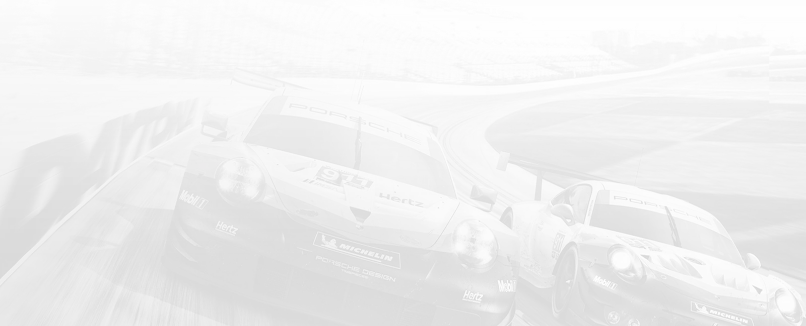 Two Porsche race cars speeding side by side on a curved racetrack.
