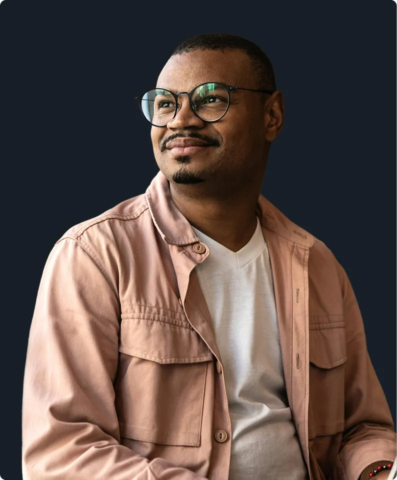 Man with short hair and glasses wearing a pink jacket for gut health and custom probiotics.