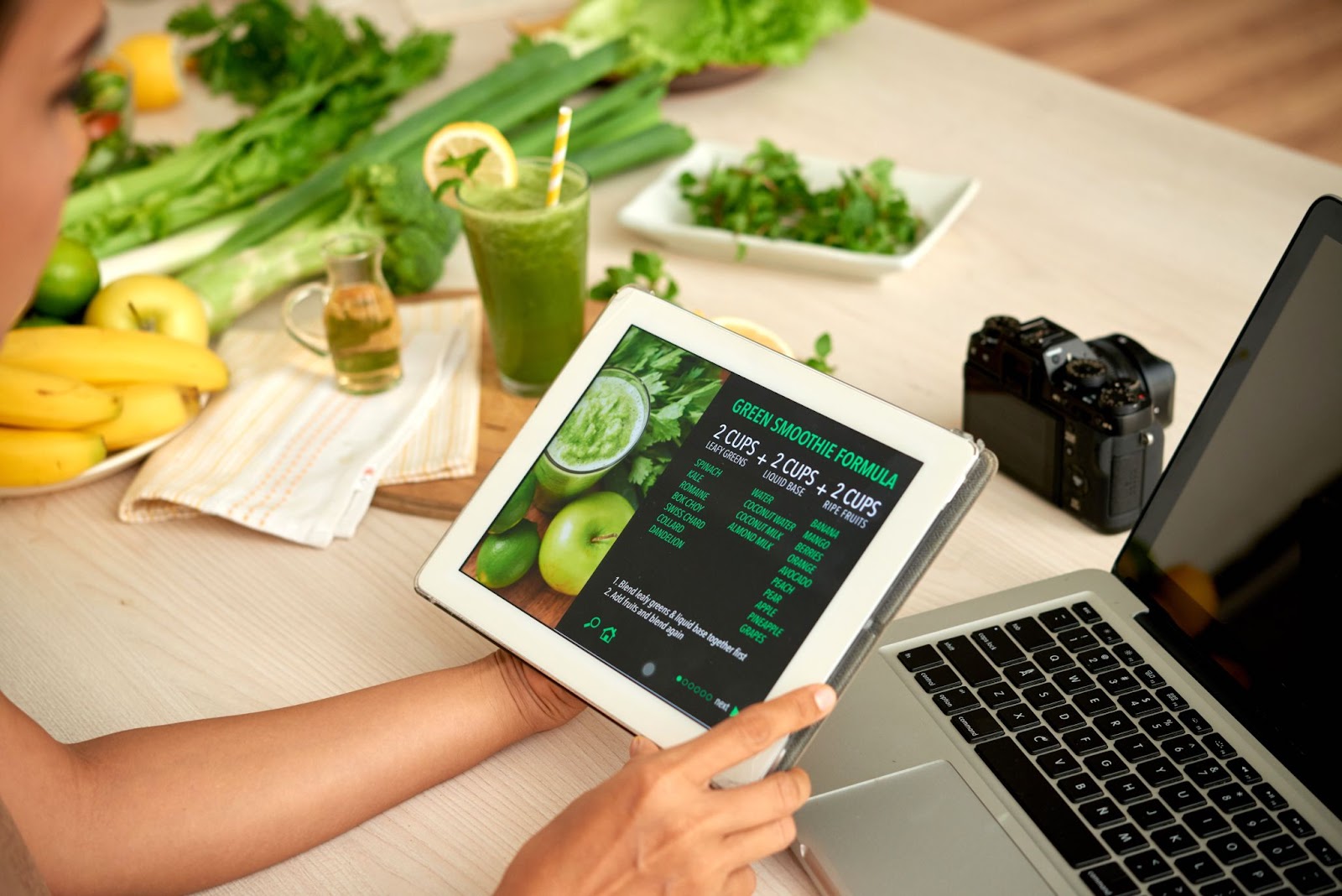a woman staring at a device's screen which shows stats of a meal