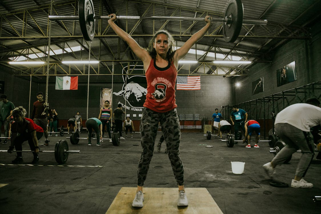 Free People in Gym Working Out with Weightlifting Stock Photo
