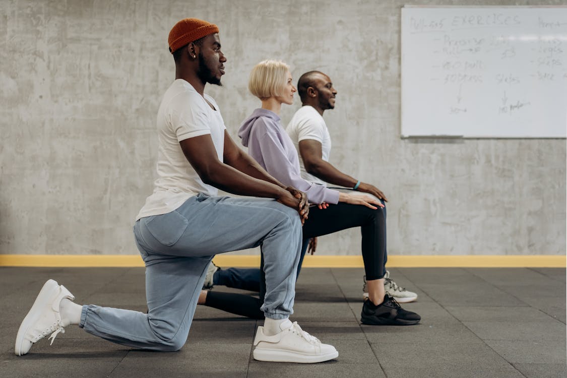 Free Three People In A Kneeling Position Stock Photo