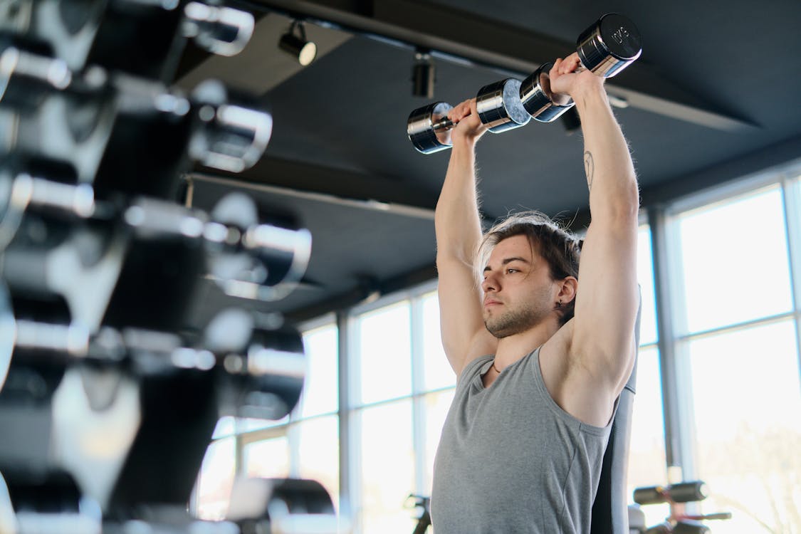 Free Man Exercising with Dumbbells Stock Photo