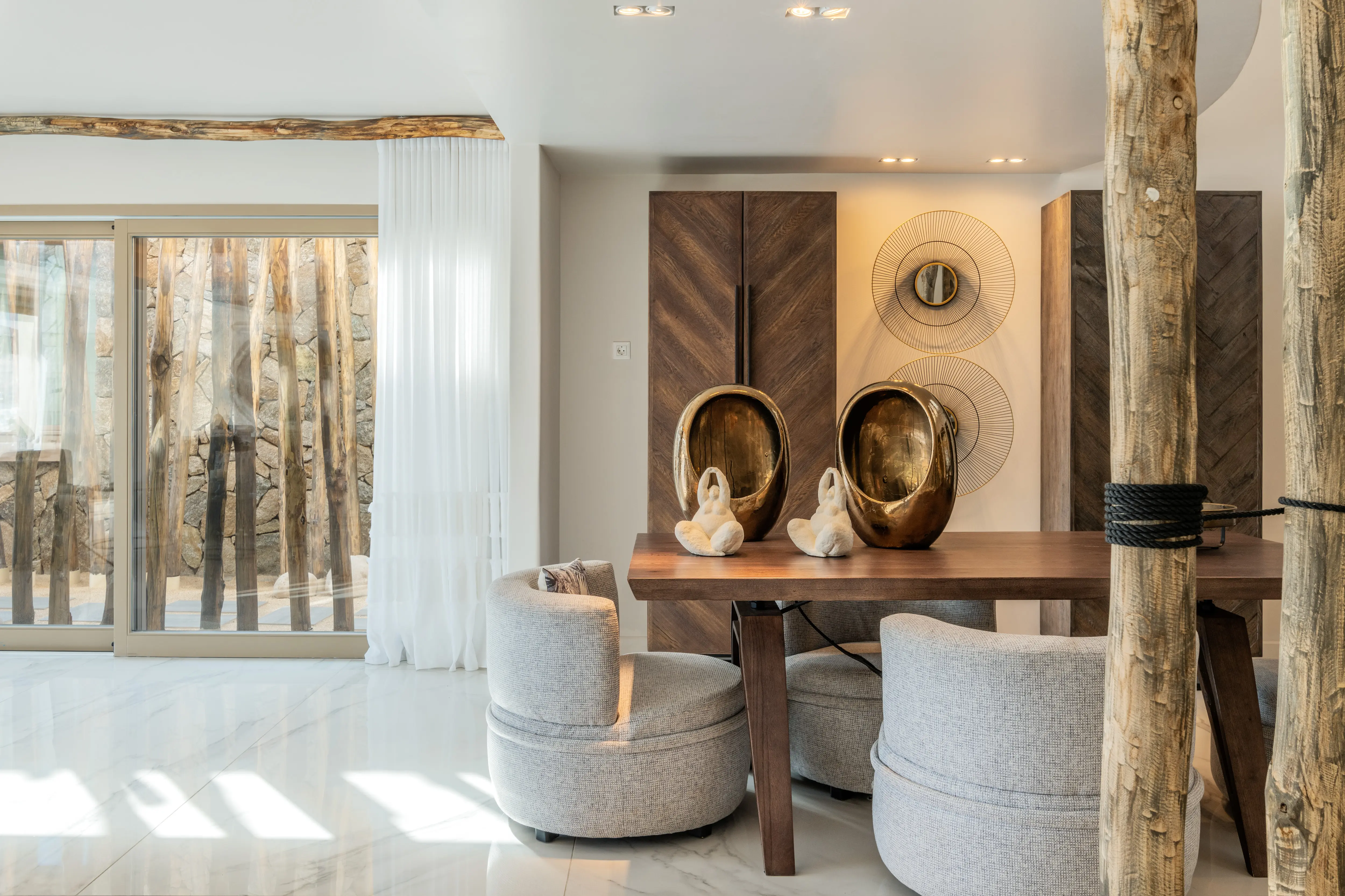 A wooden table at a  bohemian-like room.