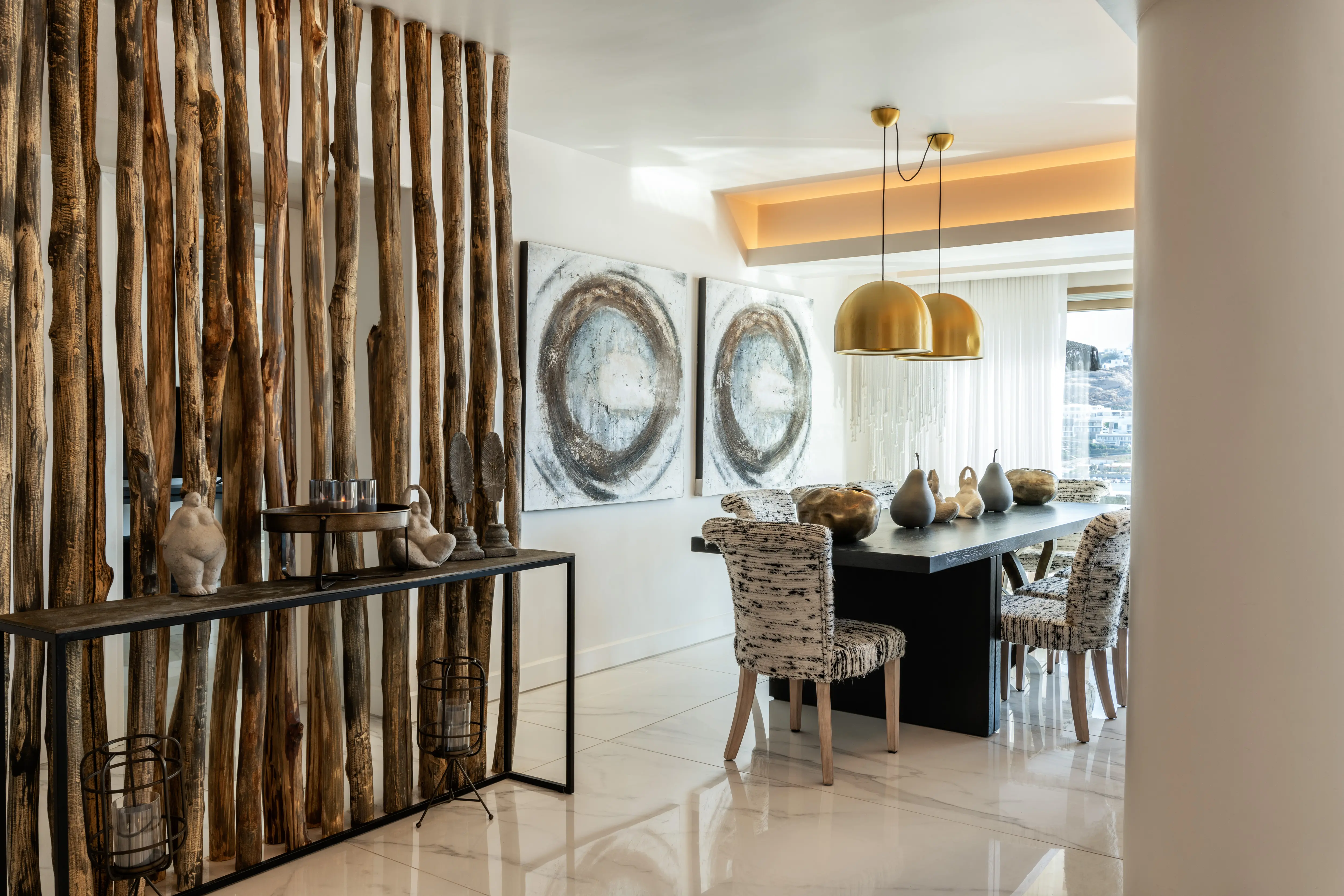 A table on a marble floor and wooden stick standing on the left.