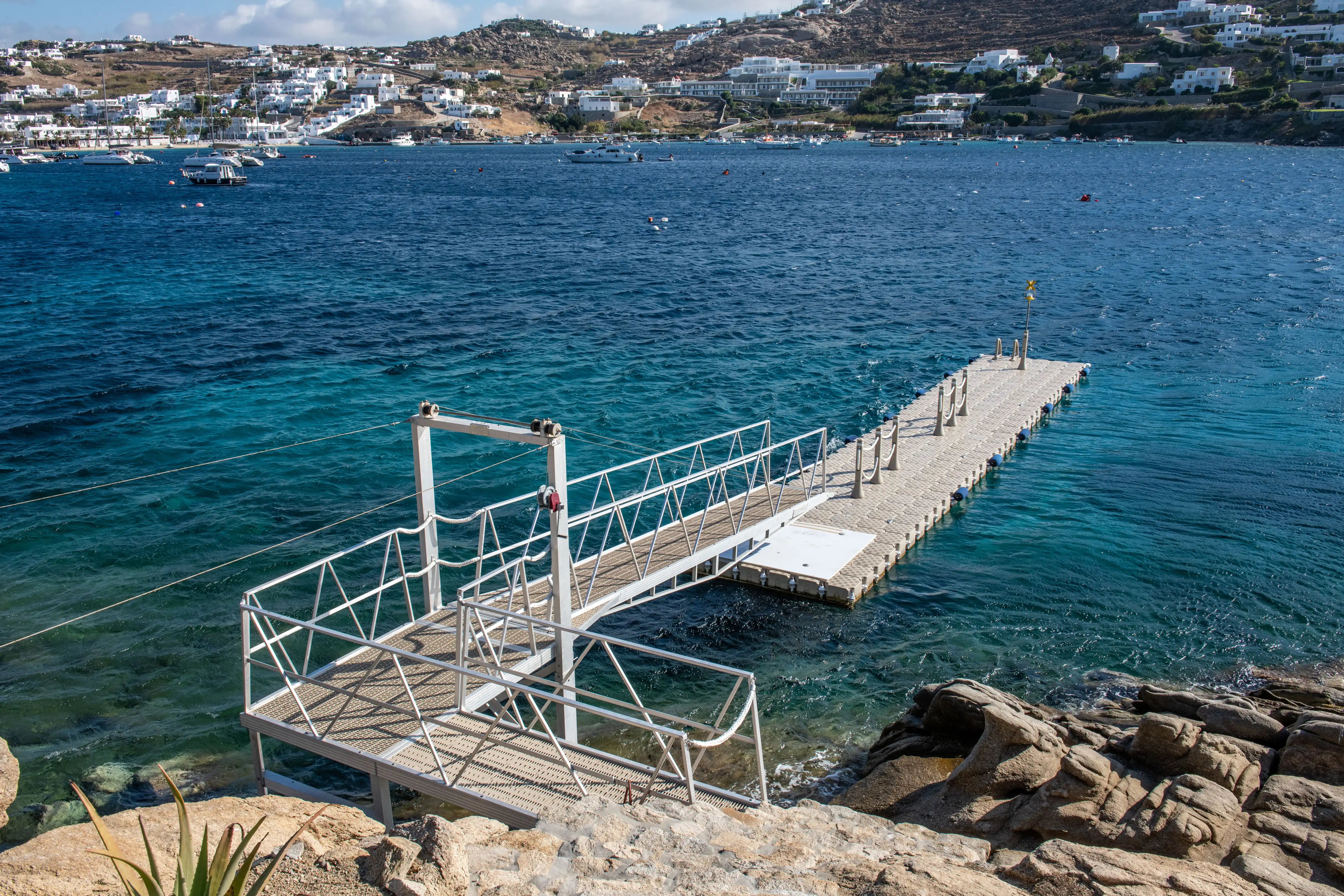 A floating dock on the blue sea in Mykonos.