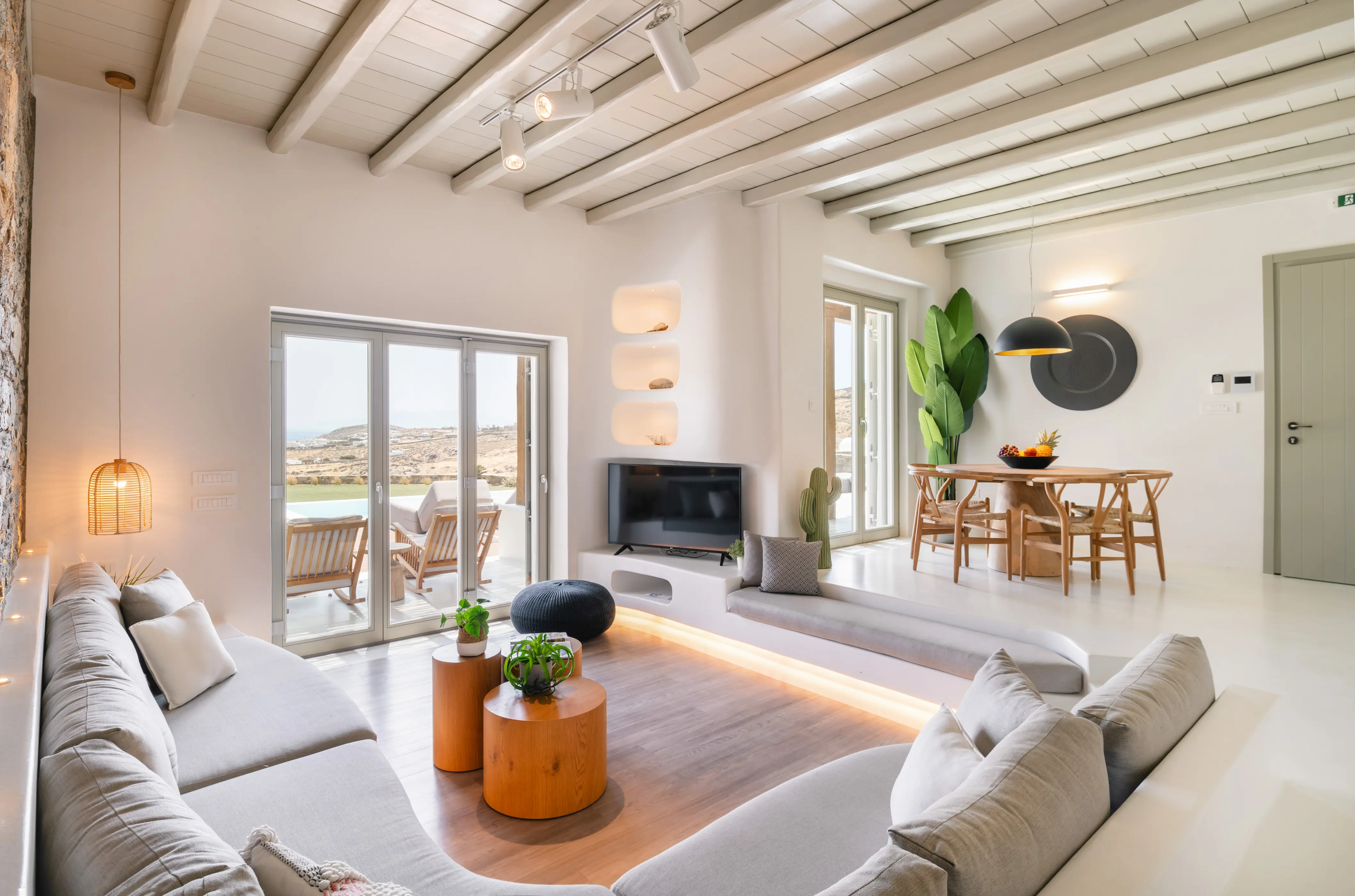 A couch in a living room with great view.