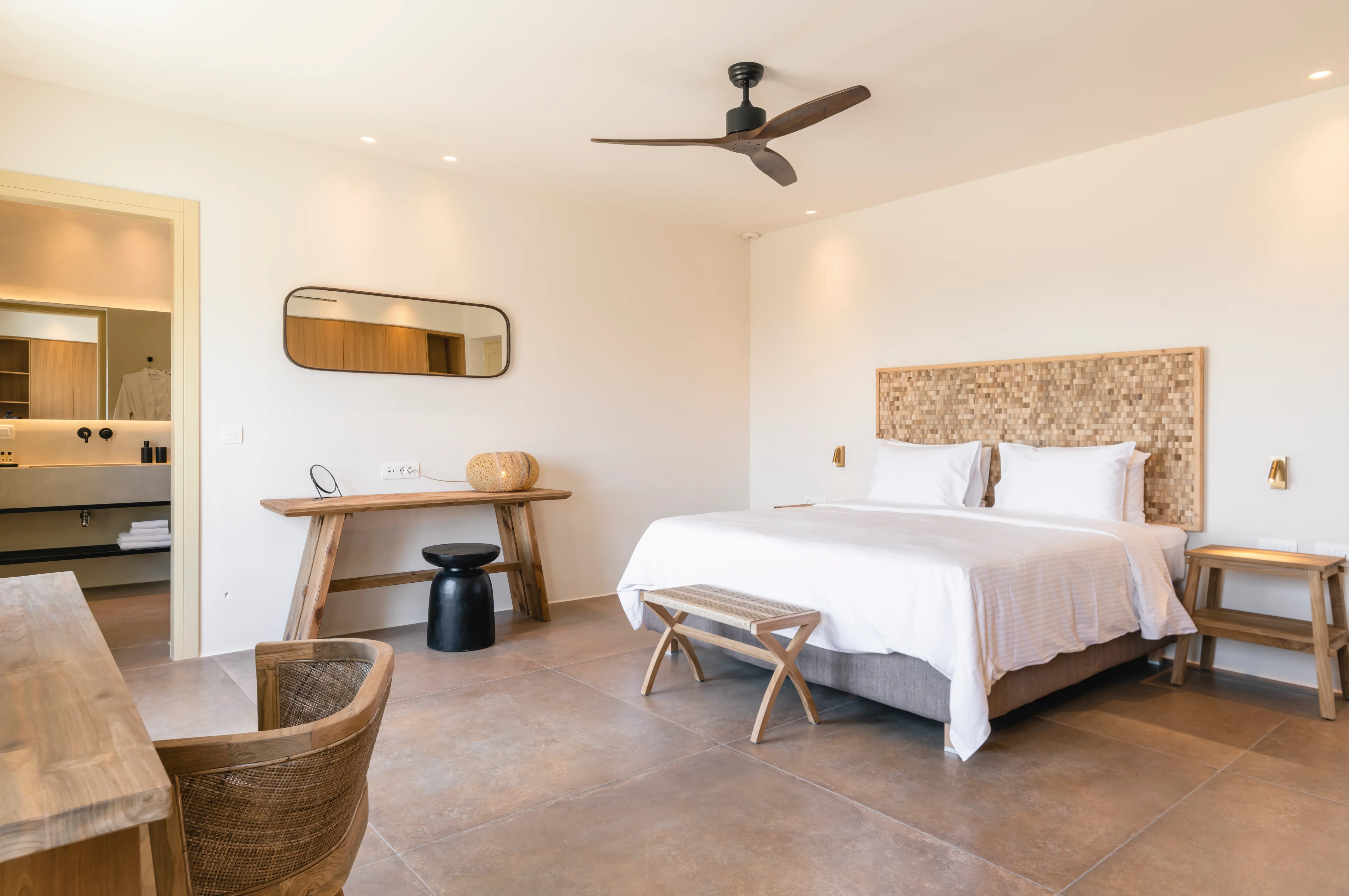 A double bed inside a spacious bedroom.