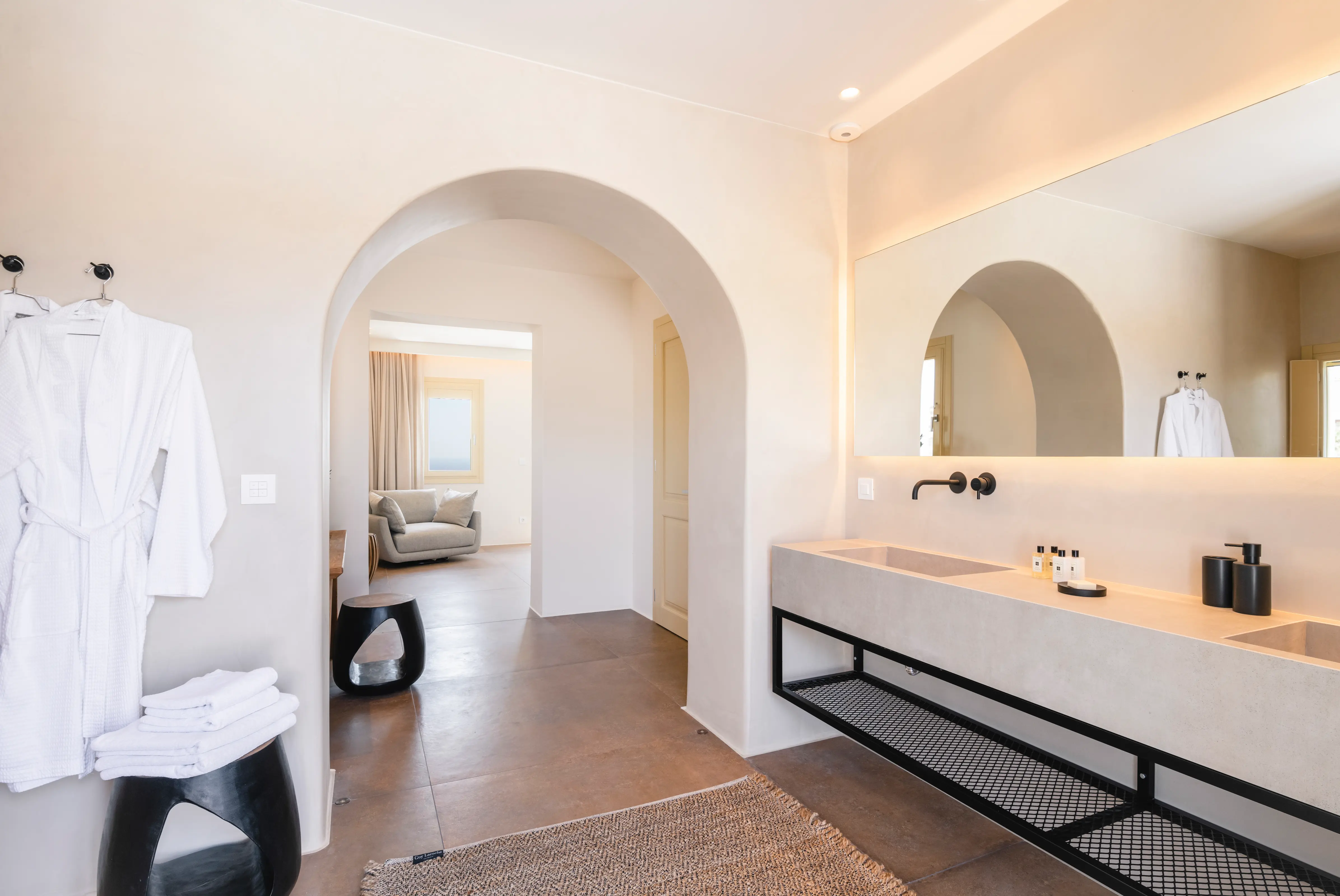 A large sink standing under a mirror in the bathroom.