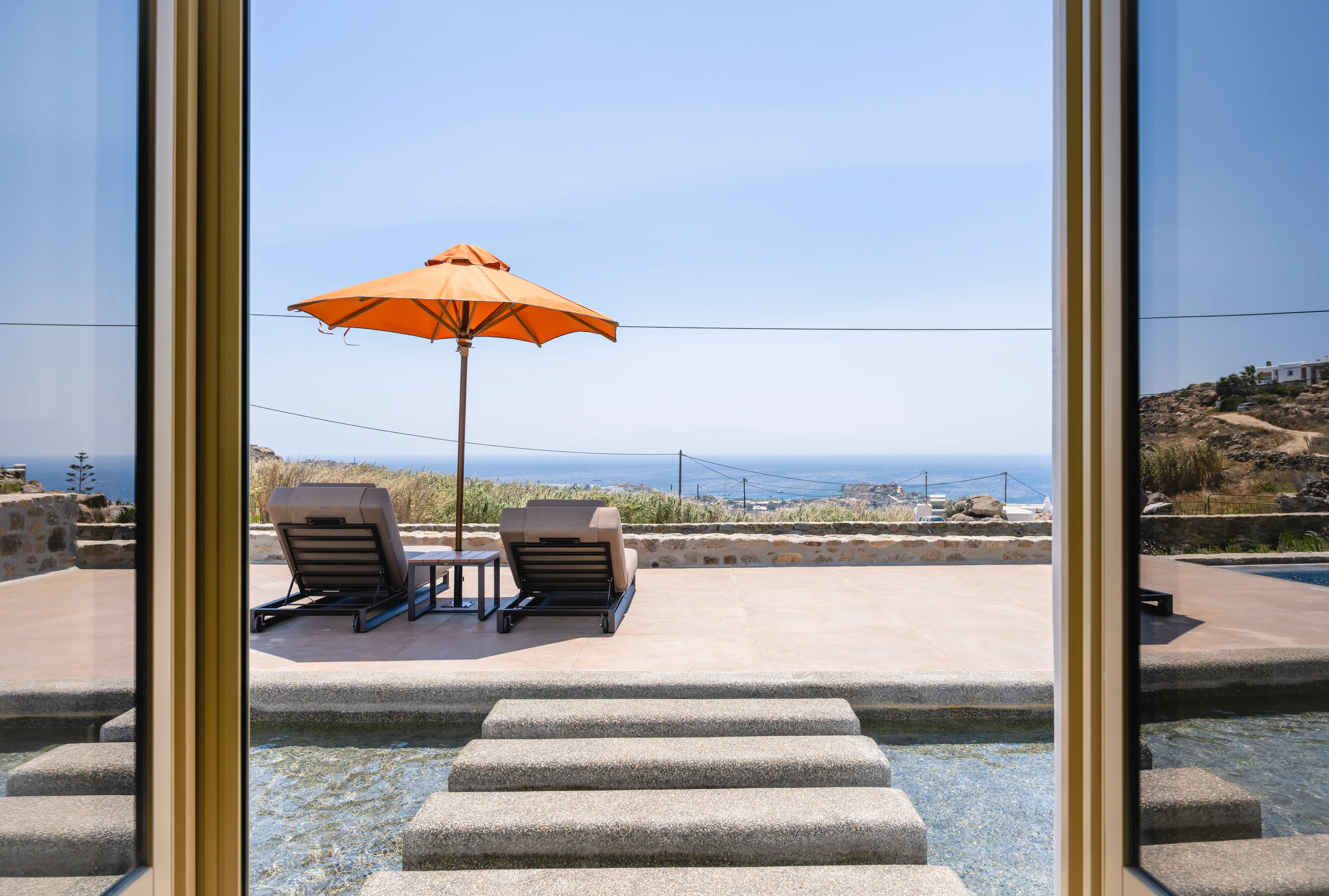 A pair of sunbeds overlooking the sea.