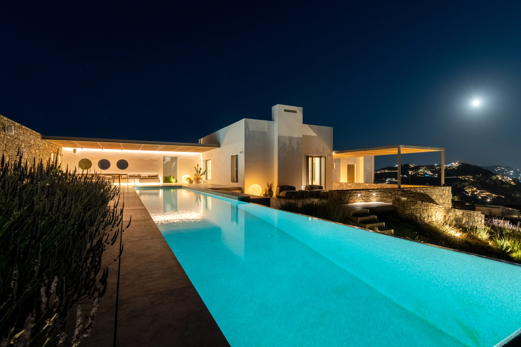 Pool and villa under the moonlight.