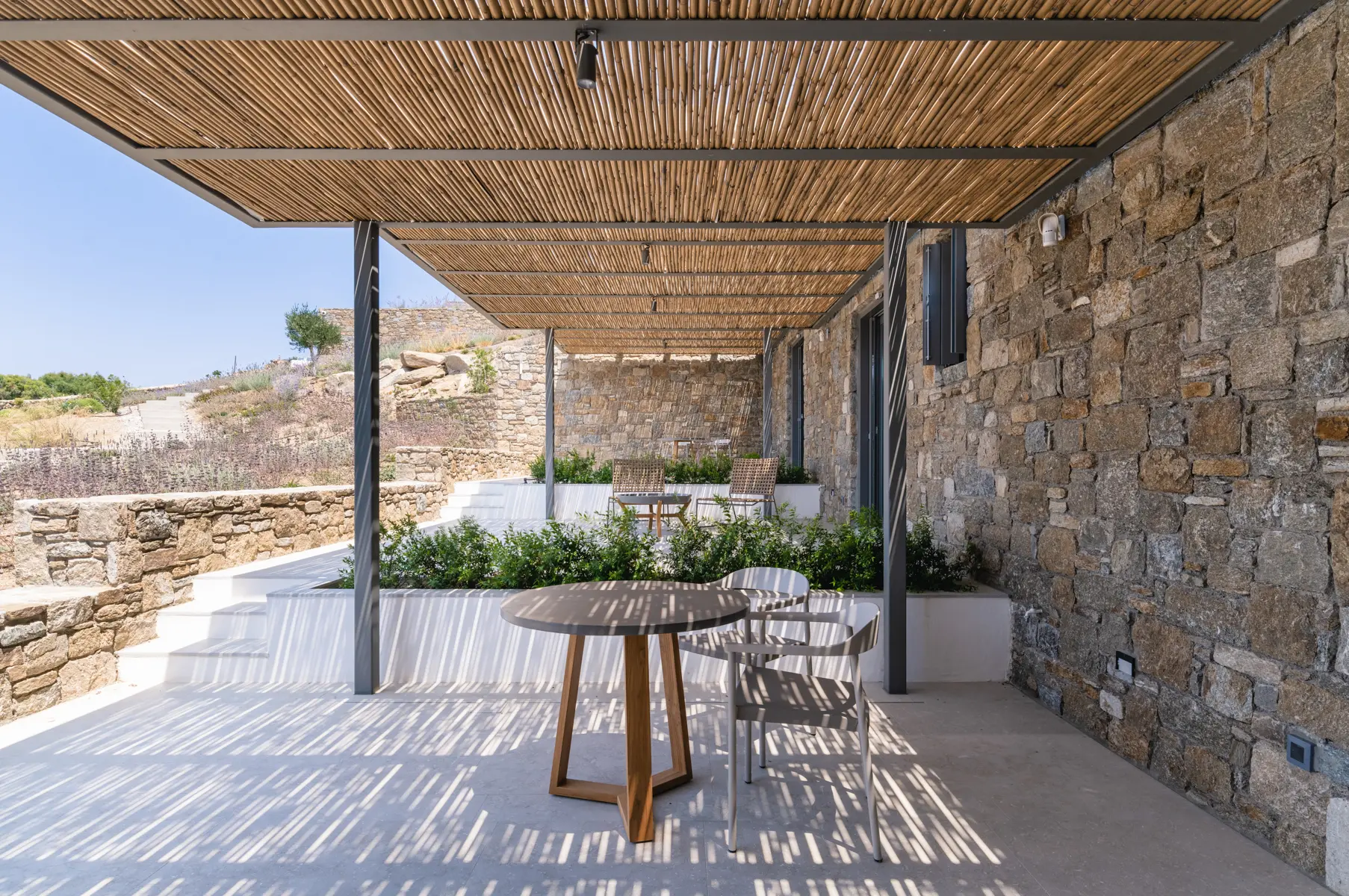 A table and two chairs under the shade.