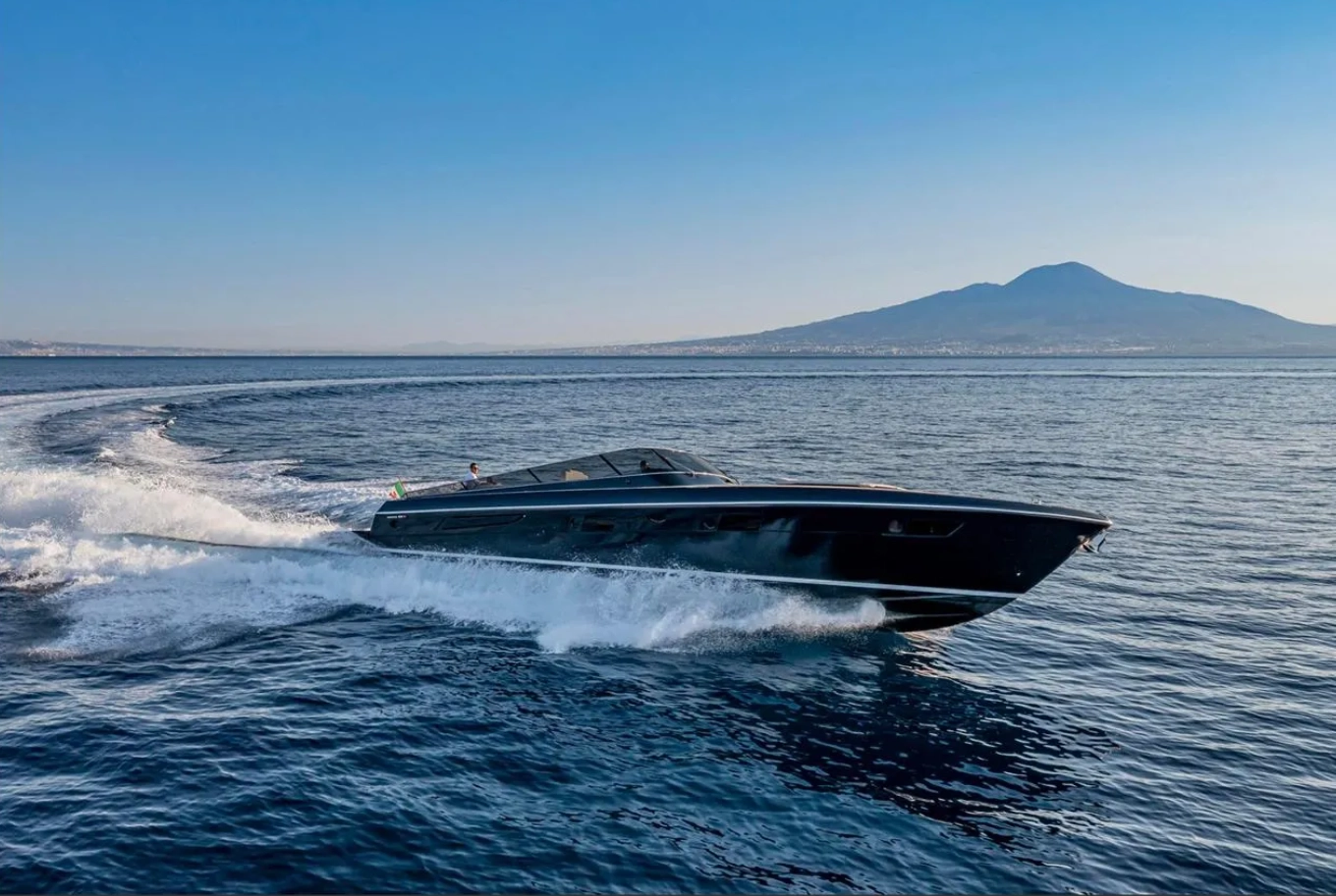 A black yacht sailing, taking a turn.