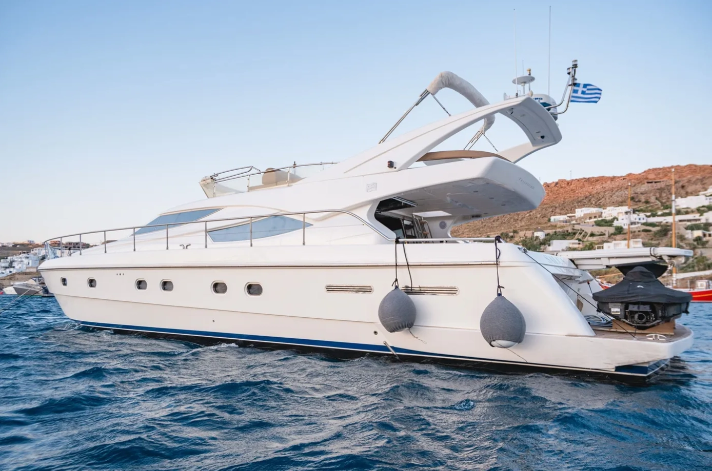 Side view of a white yacht sailing.