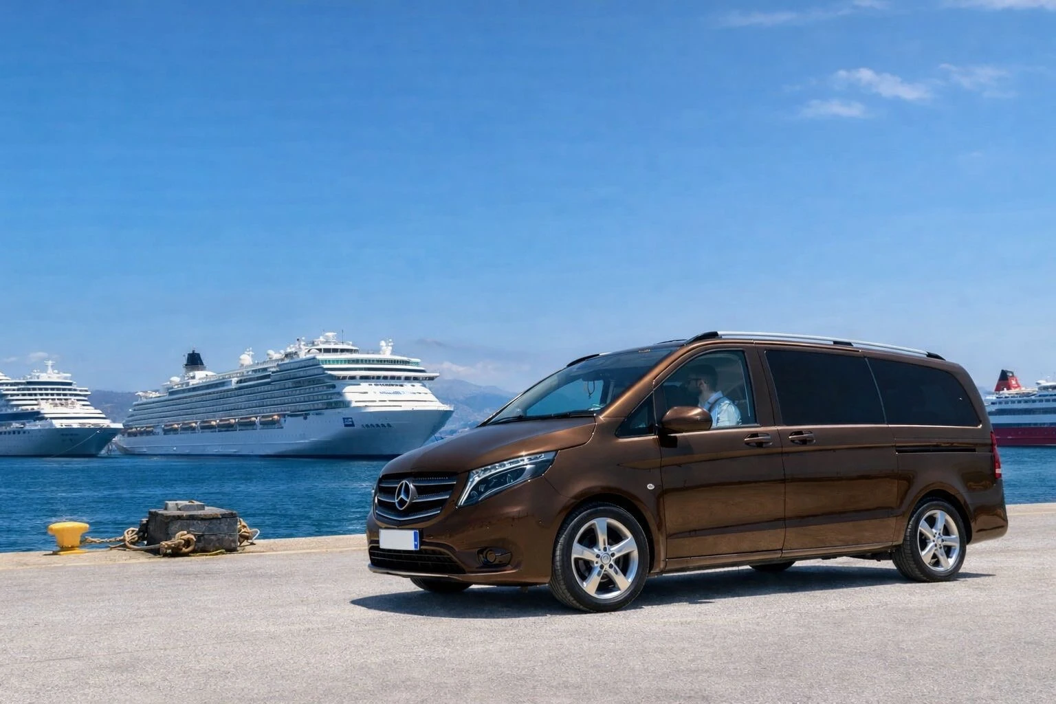 A brown van in front of two cruiseships.