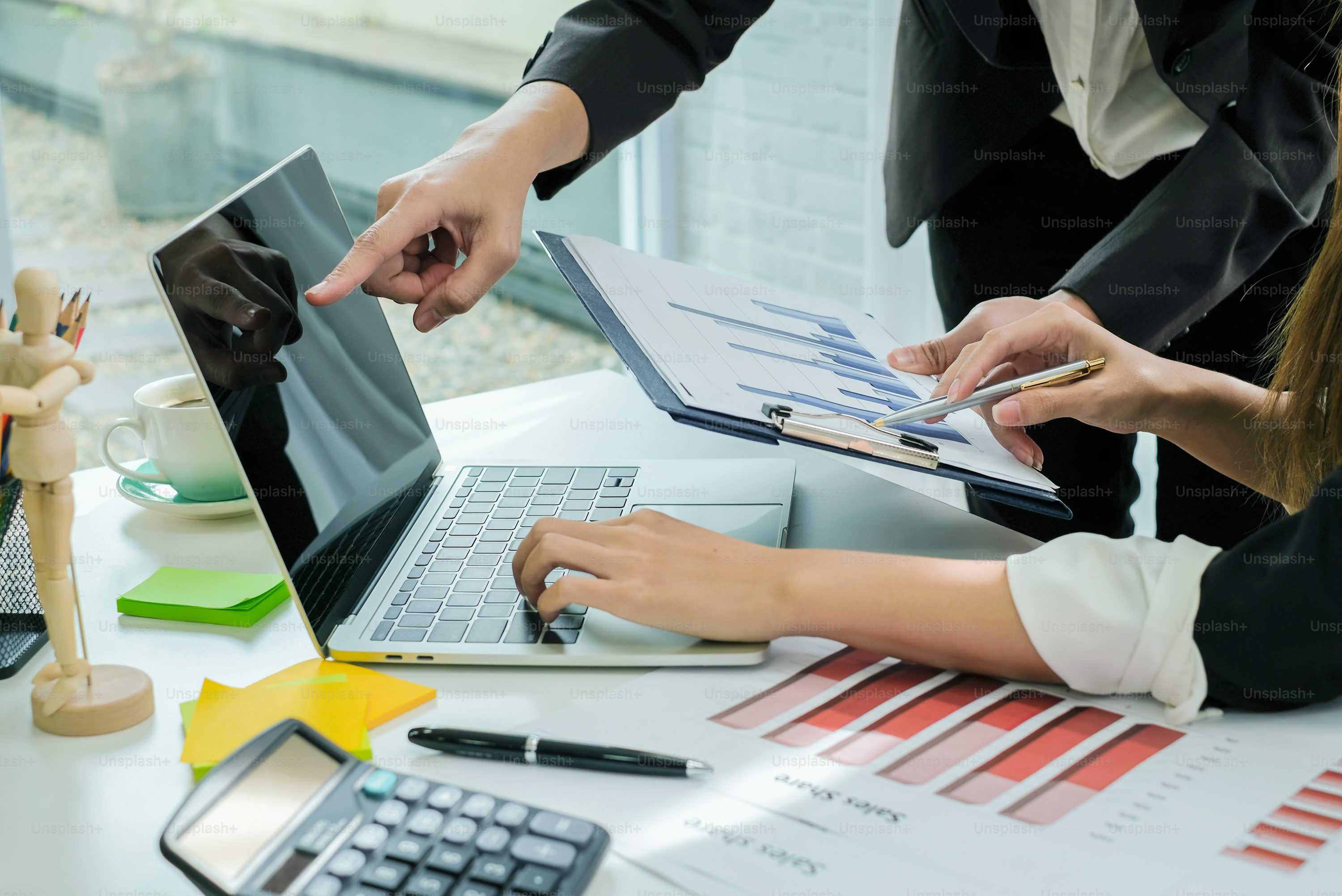 Business people brainstorming ideas for business investment strategies, charts and documents for business.