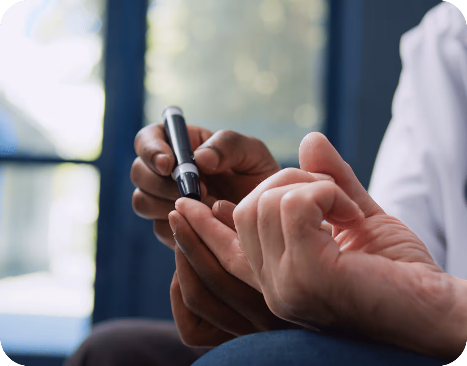 Person using a lancet device to prick a finger for blood glucose testing.