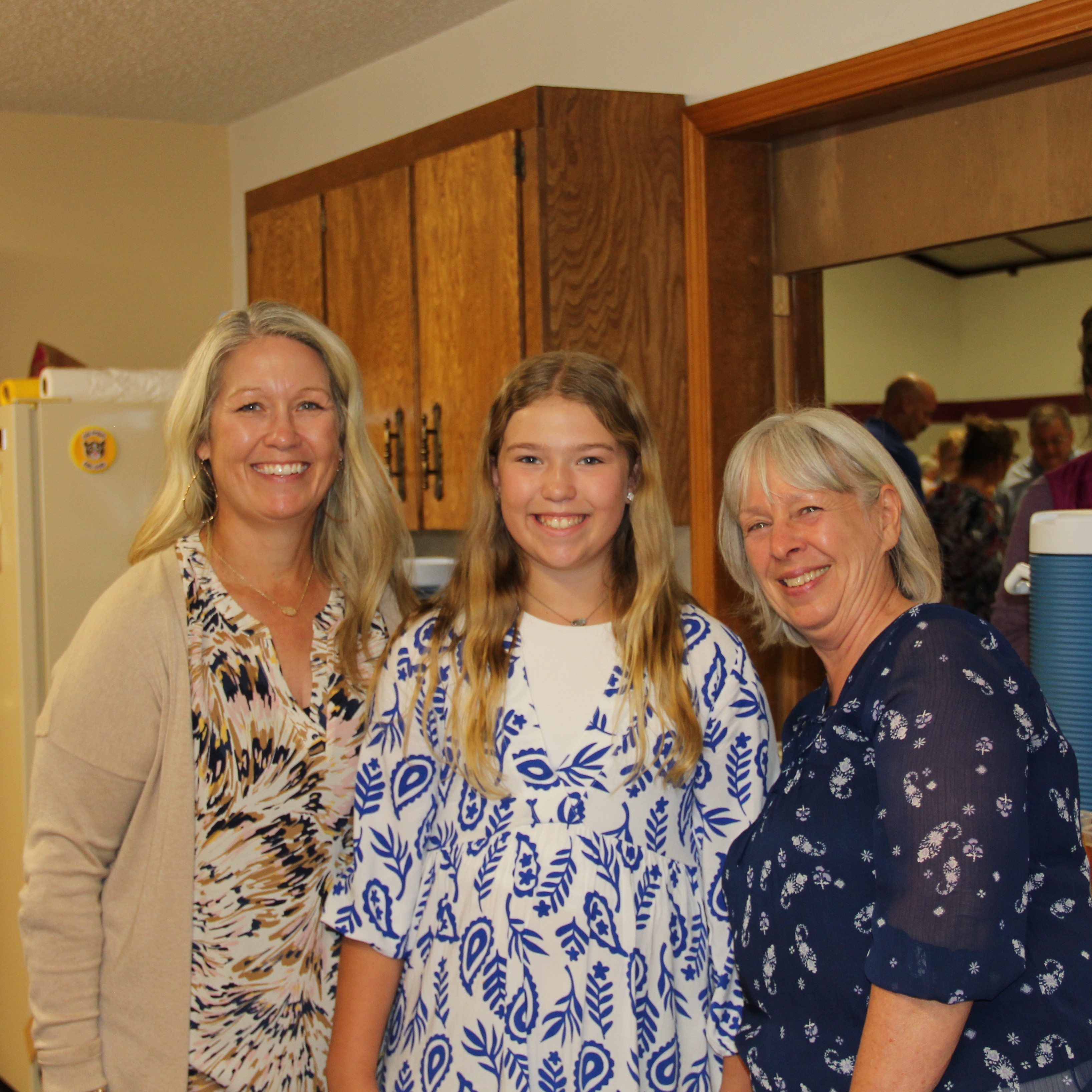 Three helpers in the kitchen at an event at Redeemer Lutheran Church in Arkansas City, Kansas. 