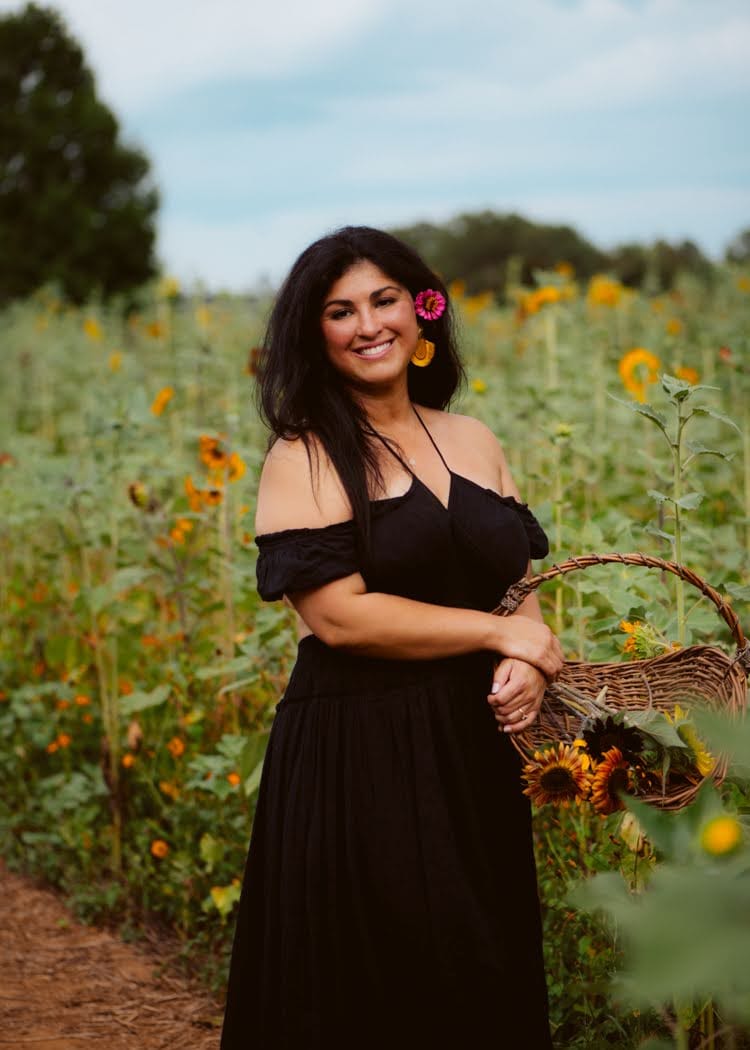 Maday Cauble, florist and co-owner of Dos Gardenias, in a sunflower field