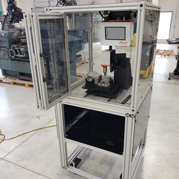 Open access door on a guarded marking station showing a mounted component fixture and vertical marking head inside the enclosure.