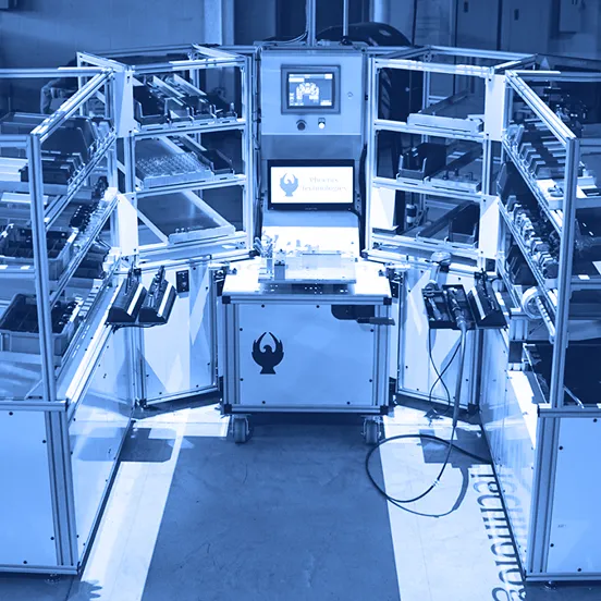 Light-guided assembly workstation with shelving, bins, control screen, and work surface arranged around a central station on a factory floor.
