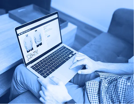 Person using a laptop to browse products on an e-commerce website.