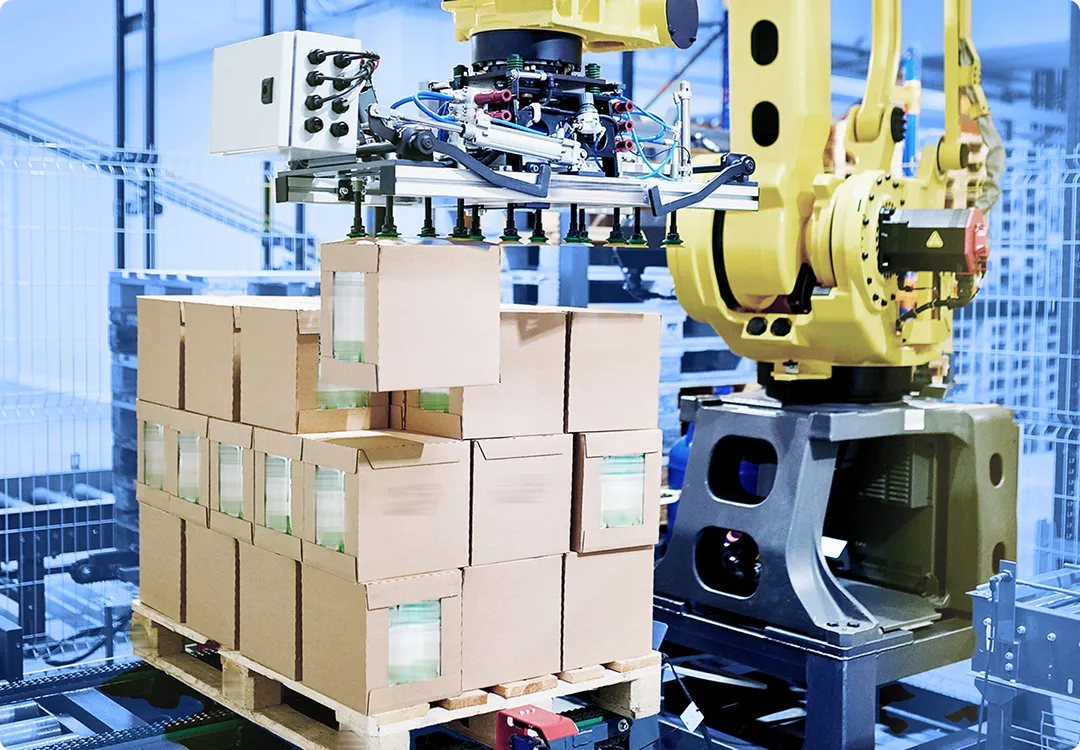 Automated packaging machine stacking boxed products onto pallets inside a manufacturing or distribution facility.