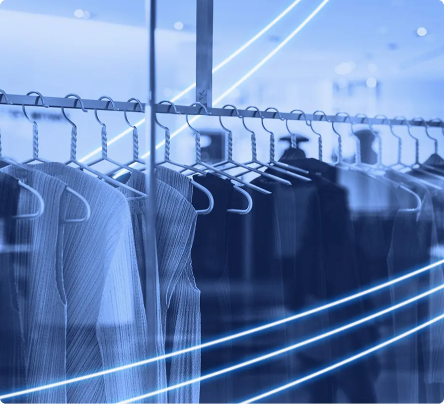 Clothing items displayed on hangers inside a retail store.