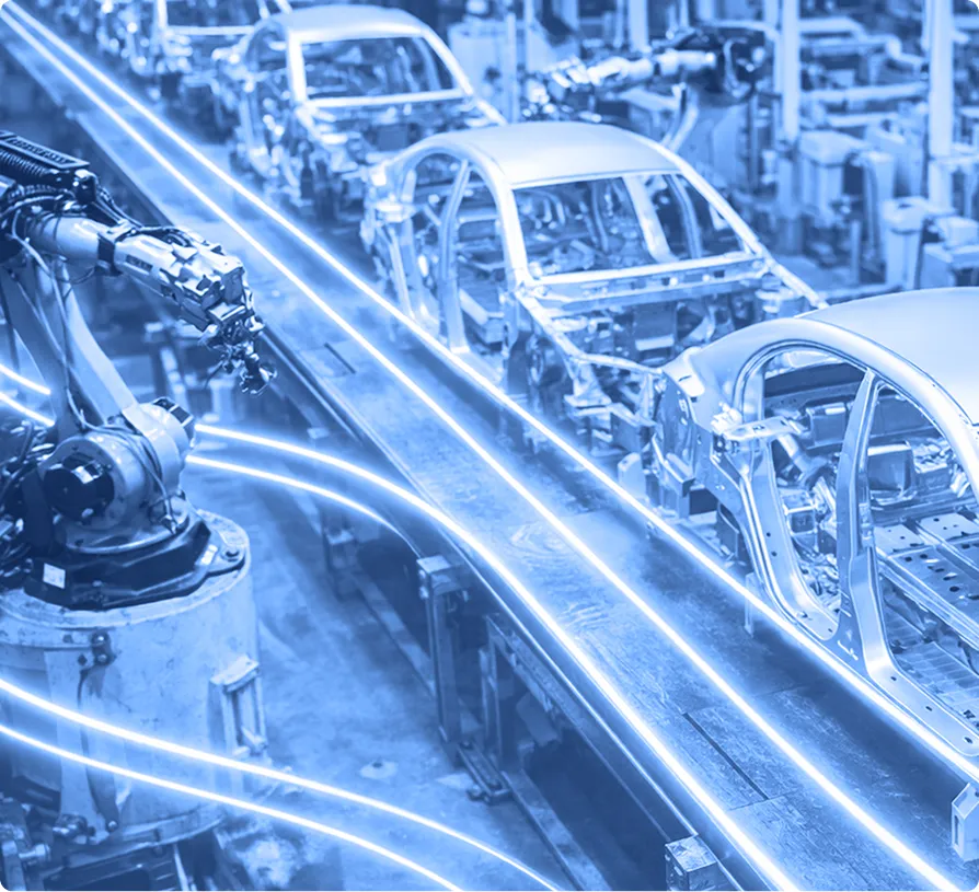 Automotive bodies aligned on an assembly line inside a manufacturing plant.