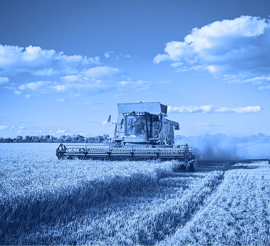 Combine harvester operating in a field during agricultural harvesting.