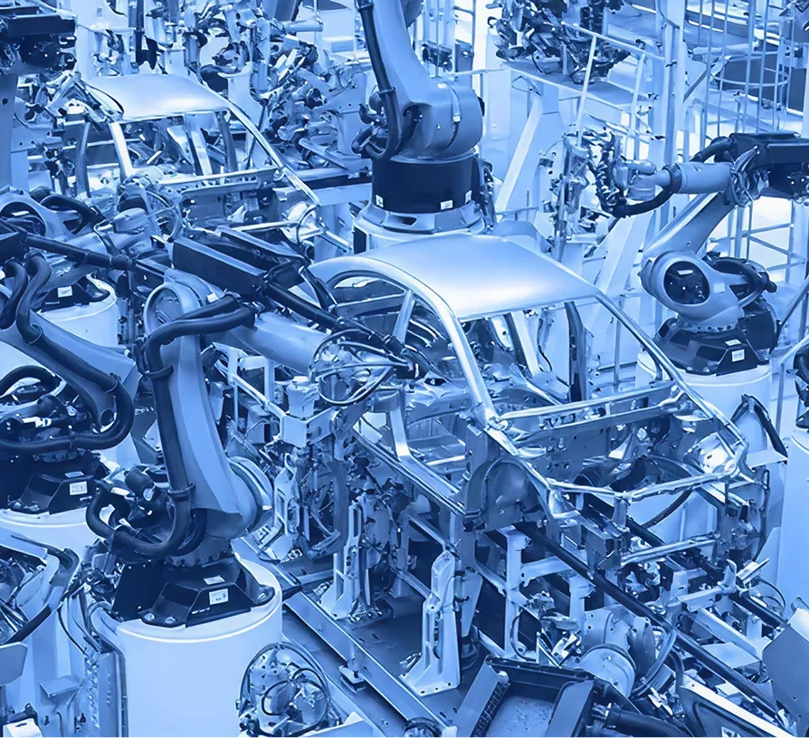 Automotive bodies aligned on an assembly line inside a manufacturing plant.