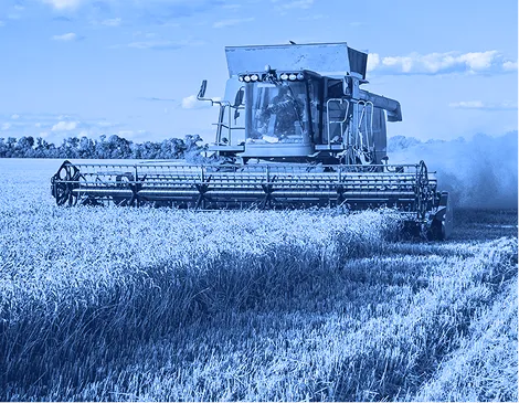 Combine harvester operating in a field during agricultural harvesting.