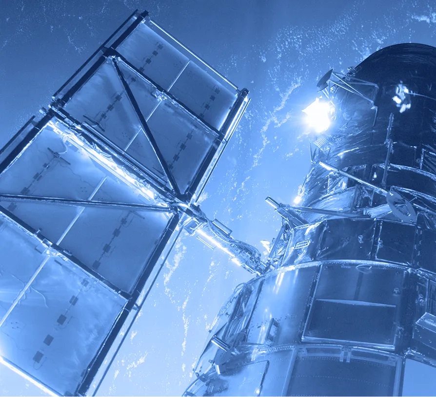 Satellite with extended solar panels viewed from below against the backdrop of Earth and space.