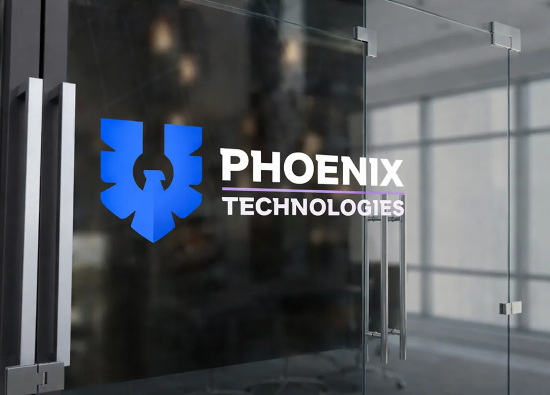 Phoenix Technologies logo displayed on a glass office wall inside a corporate workspace.