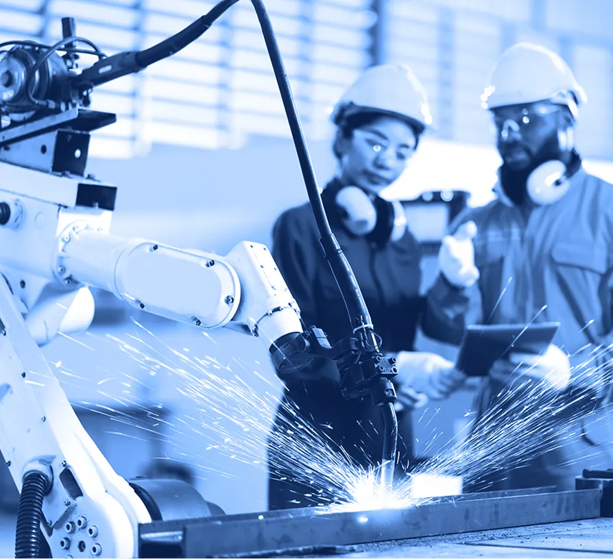 Workers operating industrial machinery in a manufacturing environment.