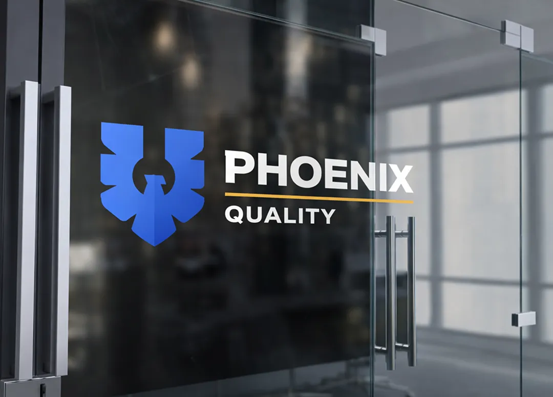 Phoenix Quality logo displayed on a glass office wall inside a corporate workspace.