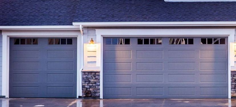 There are two garage doors on the front of a house.