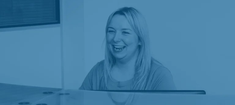 ACS employees happily talking in office setting