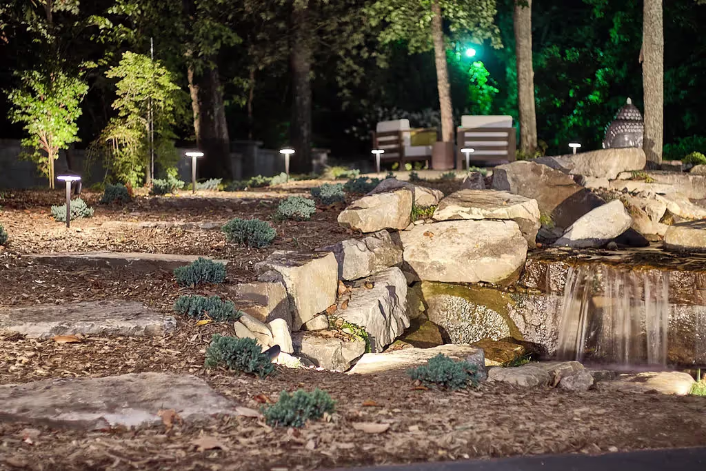 Backyard lighting a stone pathway
