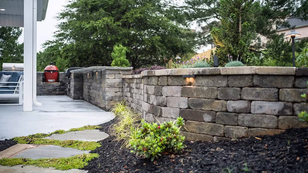 Backyard patio, large pavers and retaining wall.